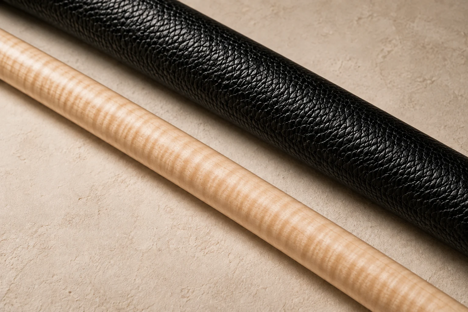 Illustrative macro view of pale maple and textured black leather cue materials